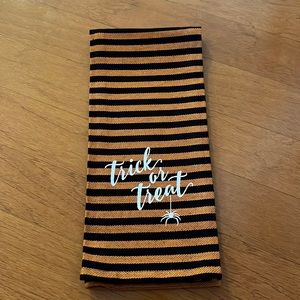 Black and orange stripes dish towel with “trick or treat”